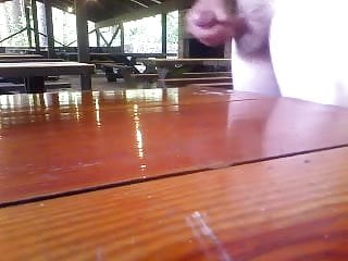 Cumming on a picnic table at work