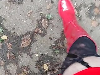 in red boots on a parking lot 