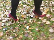 Lady L walking with red high heels.