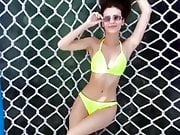 Victoria Justice laying out in a yellow bikini