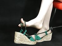 Asian feet showing in wedge espadrille style sandals. Zoom.