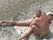 2 men wank and play on beach