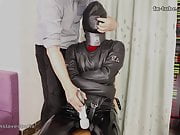 Red hair leather slave girl in hood and straitjacket